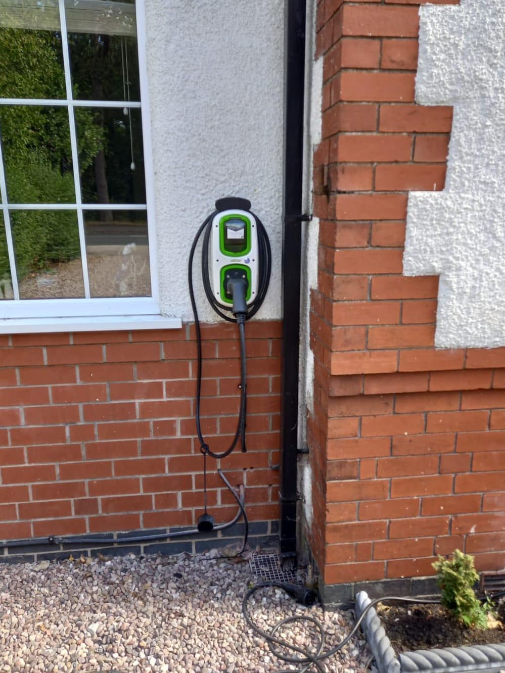 Wall-mounted car charger installed on a house by Wirrelec
