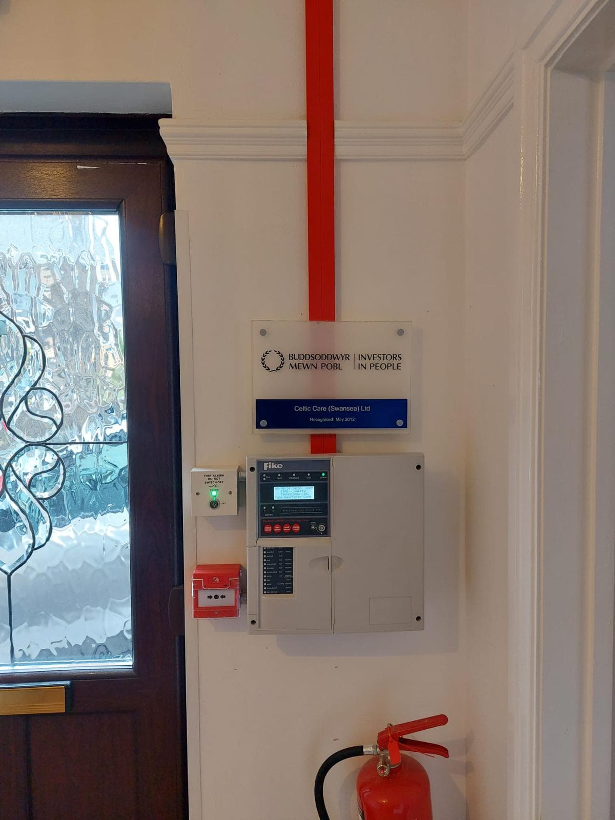 Fire alarm panel installed by Wirrelec beside a fire exit